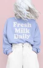 Load image into Gallery viewer, Oversized sweatshirt with Fresh Milk Daily artwork screen printed across the front, shown on model.
